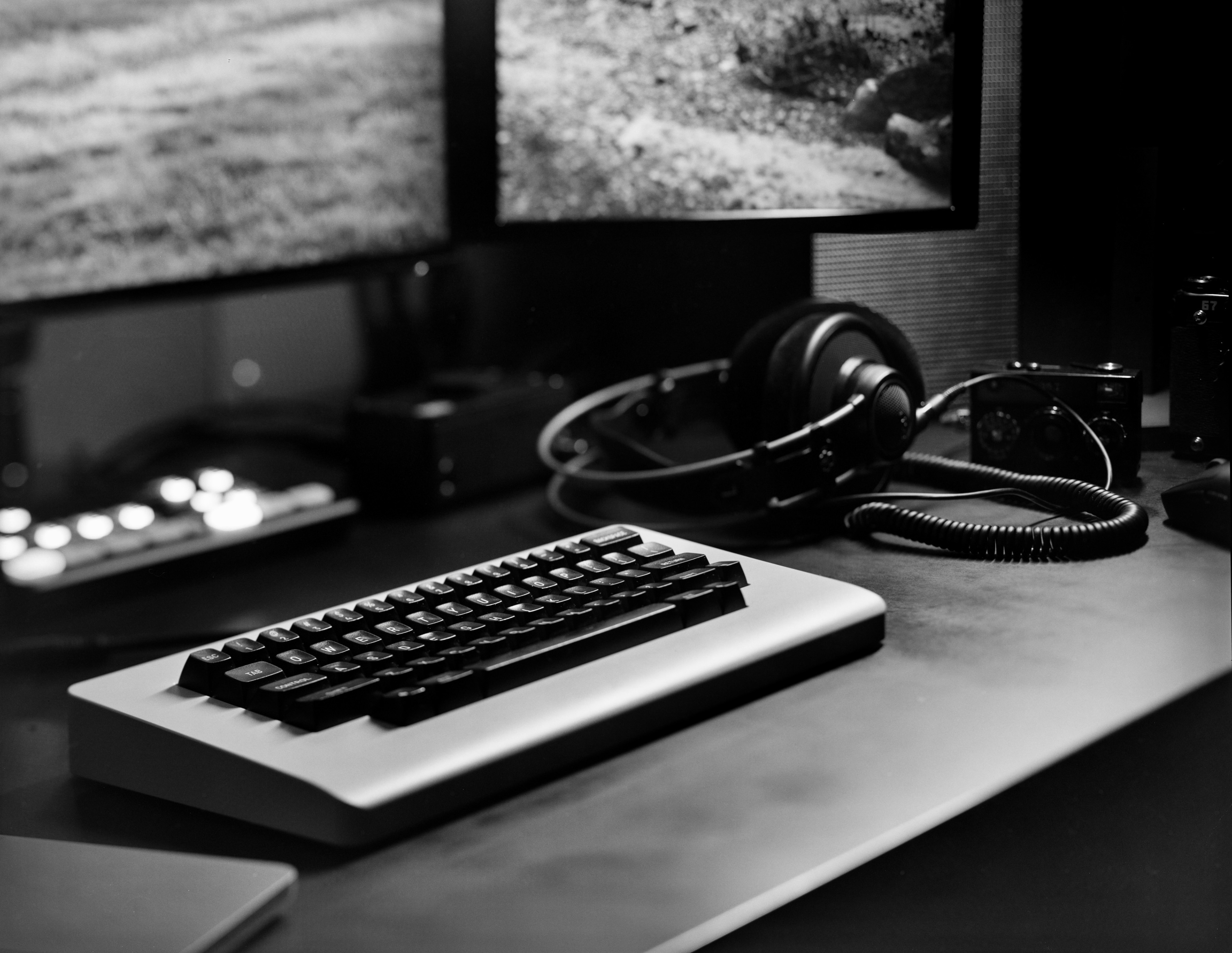 black and white, mechanical keyboard on a desk in a moody creative environment